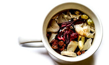 Load image into Gallery viewer, Liquorice root, hibiscus, cinnamon, rose petals, cardamom, clove in a cup.
